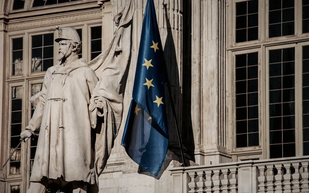 European Union flags flying in front of an institutional building