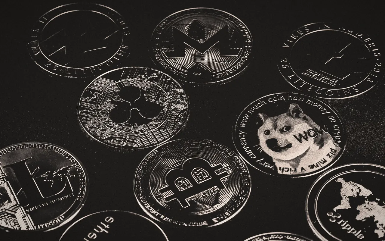 Physical Bitcoin and other cryptocurrency coins on a dark table