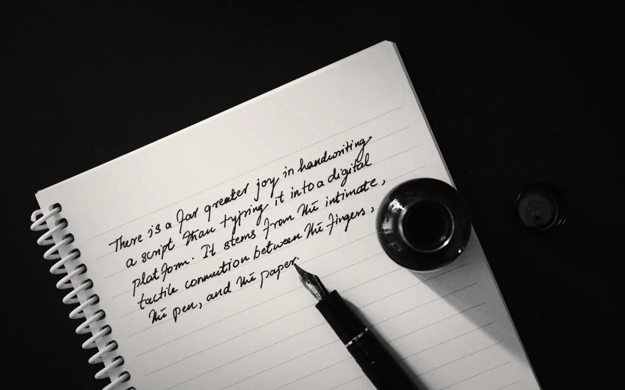 Hand writing a list of words with a pen on a sheet of paper