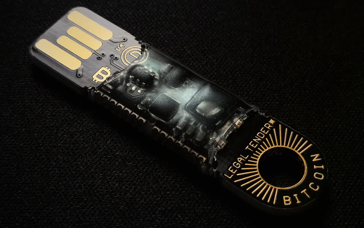 Black USB stick with the bitcoin logo, like a cold wallet, on a dark background