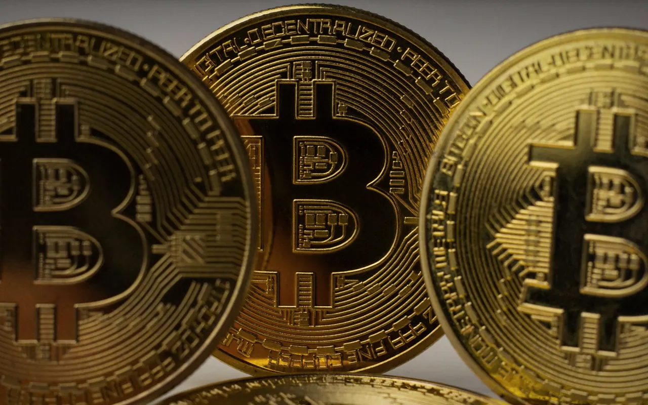 Bitcoin and other cryptocurrency coins on a dark table